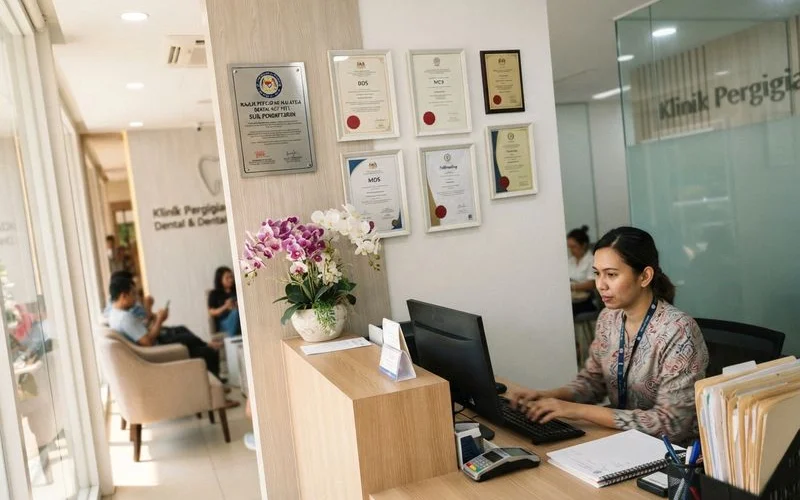 A dental clinic's registration and qualification certificates displayed on a wall